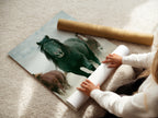 A woman is carefully rolling a fine art poster paper featuring wild horses. This high-quality print captures the beauty of Western animal wall decor. Perfect for living rooms bedrooms or offices seeking a country or farmhouse style. This artwork is great for ranchers or anyone that appreciates wildlife art. The fine art paper ensures lasting quality.