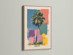 Artwork in an oak frame is mounted on a wall. The artwork includes a palm tree and geometric shapes in multiple colors. The oak frame adds a warm natural touch. Perfect for adding a piece of framed artwork to your home or office.