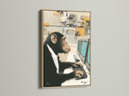 A Monkey Office Art Print framed in oak hangs on a white wall. This chimp canvas print adds humor to any office space. The artwork features a chimpanzee working at a computer. This funny animal art is perfect for entrepreneurs. It also suits animal lovers who want elevated decor.