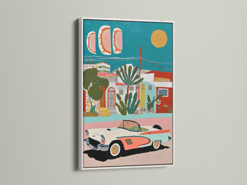 Coastal wall art featuring a vintage car in a Mediterranean village. This artwork is framed in white. The white frame enhances the coastal and tropical style. The teal and coral colors bring a fresh vibrant feel to any space. Perfect for bedroom wall art.