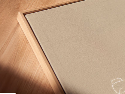 Close-up angled view of a Zen Stones canvas print in a floating frame.  The minimalist wall art adds a contemporary touch. Perfect as spa decor or calming artwork.  Elevate your bathroom artwork with this zen-inspired piece.