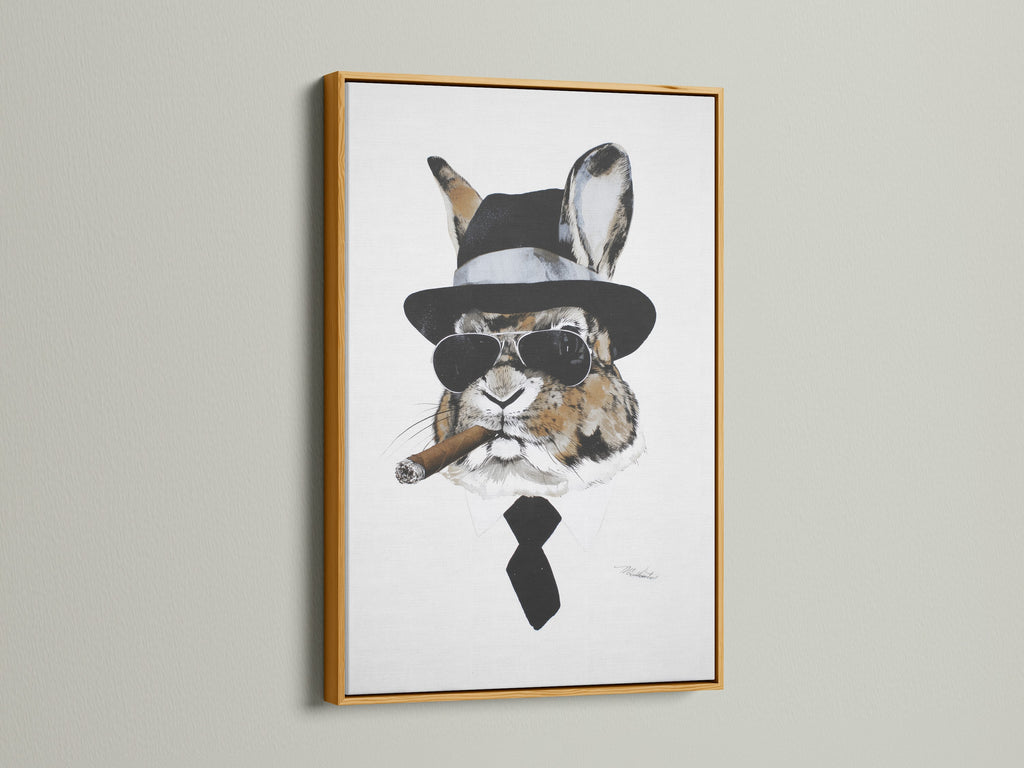 Gentleman Rabbit artwork in a gold frame. This funny animal print adds a touch of luxury. The gold frame enhances the artwork's appeal. Ideal for adding a quirky vintage touch. Great for living rooms or man caves. It is a conversation starter.