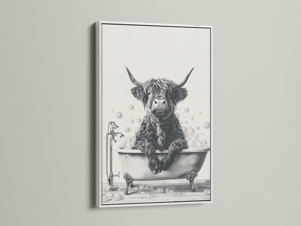 This highland cow artwork is framed in white. It creates a clean fresh look. A cow sits in a bathtub full of bubbles. This bathroom wall art offers a farmhouse touch. Perfect for adding rustic charm to your powder room. Find more animal canvas options.