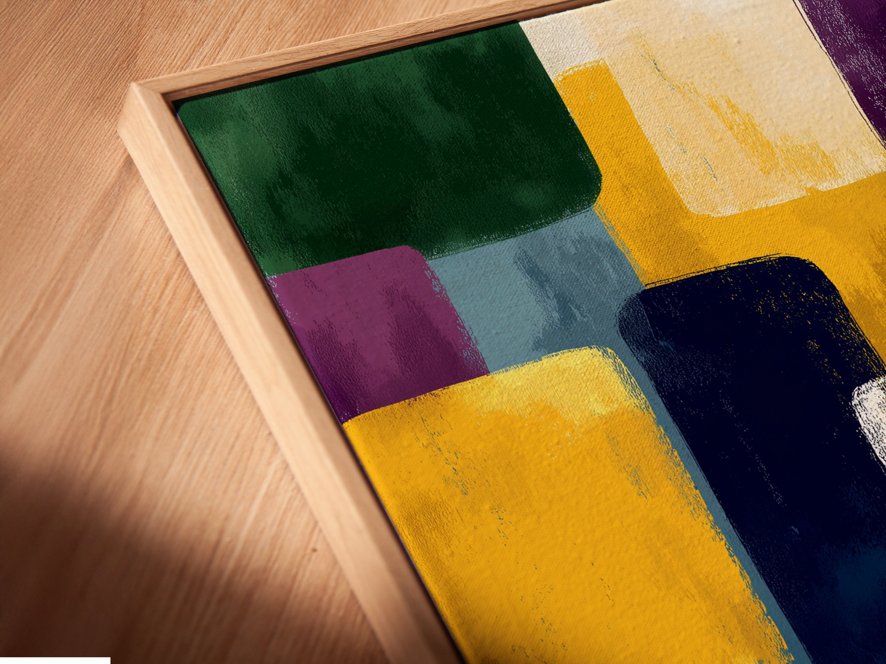 Angled close up of a canvas print in a floating frame. The Abstract Geometric artwork features colorful blocks. Enhance your space with this modern wall art. The contemporary print is perfect for offices and homes.