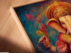 Angled close up of a Ganesha canvas print in a floating frame. The Hindu God wall art enhances spiritual decor. It is ideal bohemian artwork for a meditation room. The colorful sacred art features an elephant god print. It adds a unique touch.