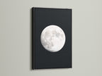 Full Moon lunar phase artwork with a black frame. This celestial wall art enhances bedroom astronomy decor. A unique moon phase art piece. This artwork brings space themed art to modern living. It makes a thoughtful astrology gift. This is a stunning night sky print. This is a full moon artwork for celestial print collections.