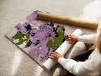 A woman is carefully rolling a fine art poster paper. The paper features an abstract floral artwork with purple and green tones. This high-quality print is perfect for creating stunning wall decor. Its vibrant colors and contemporary design enhance any space.