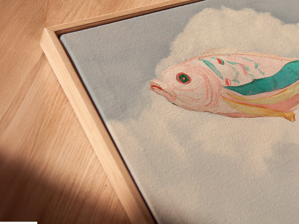 A close-up shows a canvas print in a floating frame. This surreal flying fish artwork is beautifully displayed. The floating frame enhances the airy feel. The pastel colors and whimsical artwork are highlighted. It is perfect for bedroom decor. The imaginative artwork adds a touch of fantasy to any space.