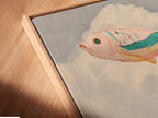 A close-up shows a canvas print in a floating frame. This surreal flying fish artwork is beautifully displayed. The floating frame enhances the airy feel. The pastel colors and whimsical artwork are highlighted. It is perfect for bedroom decor. The imaginative artwork adds a touch of fantasy to any space.