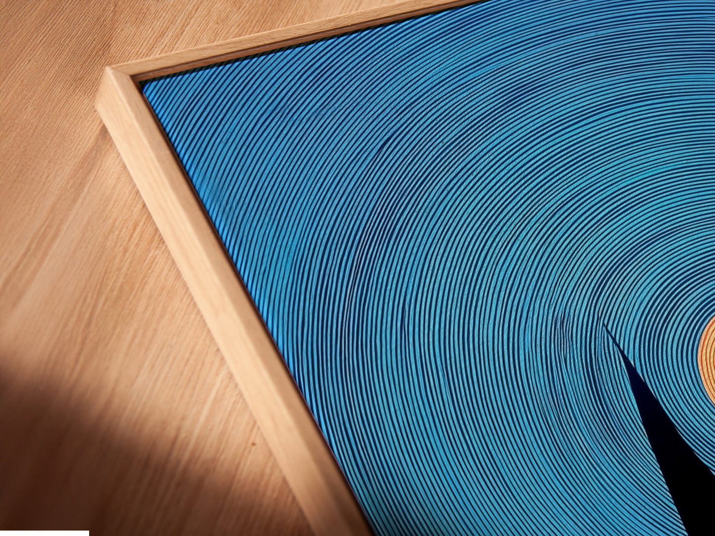 A close-up shows a canvas print in a floating frame. The nautical art features navy blue sailboats and a sunset. This coastal artwork is perfect for living room wall art. The print is a stylish addition to any space. It suits minimalist Scandinavian or coastal styles.