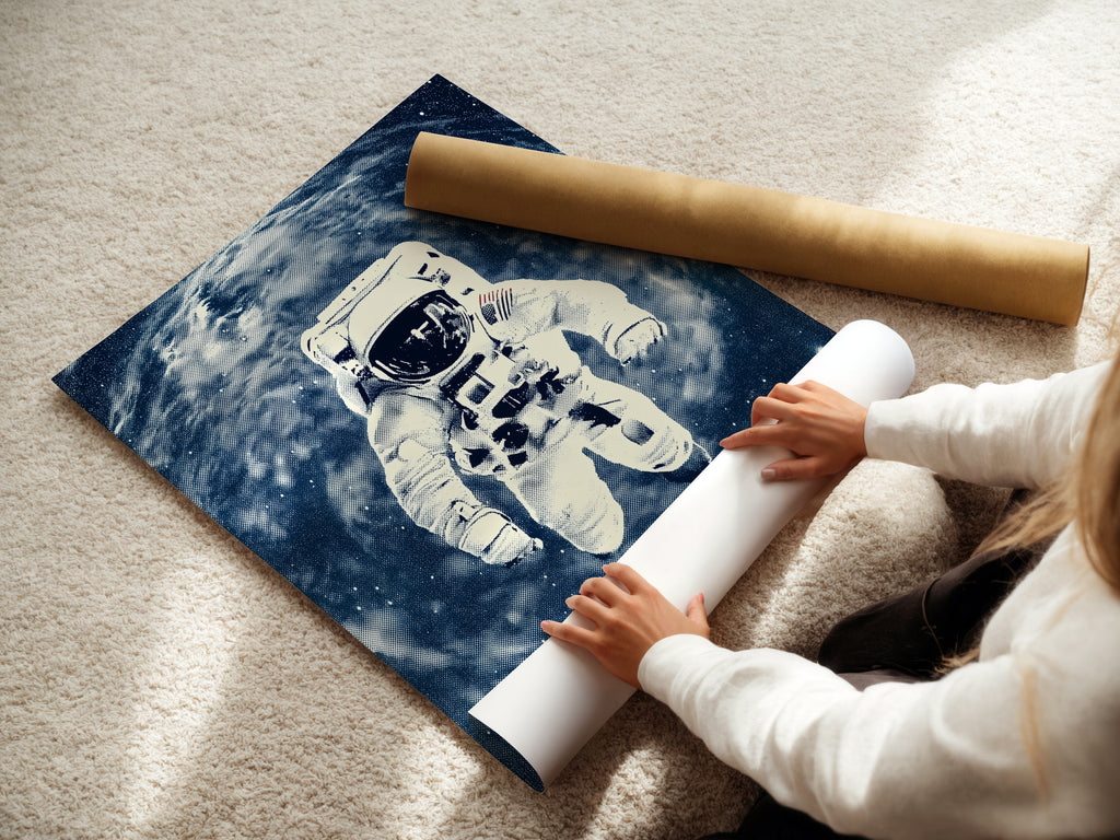 A woman carefully rolls a fine art poster paper featuring astronaut space art. The blue galaxy artwork is preserved. This NASA poster is perfect for office decor. It is ideal for space themed decor or cosmic art enthusiasts.