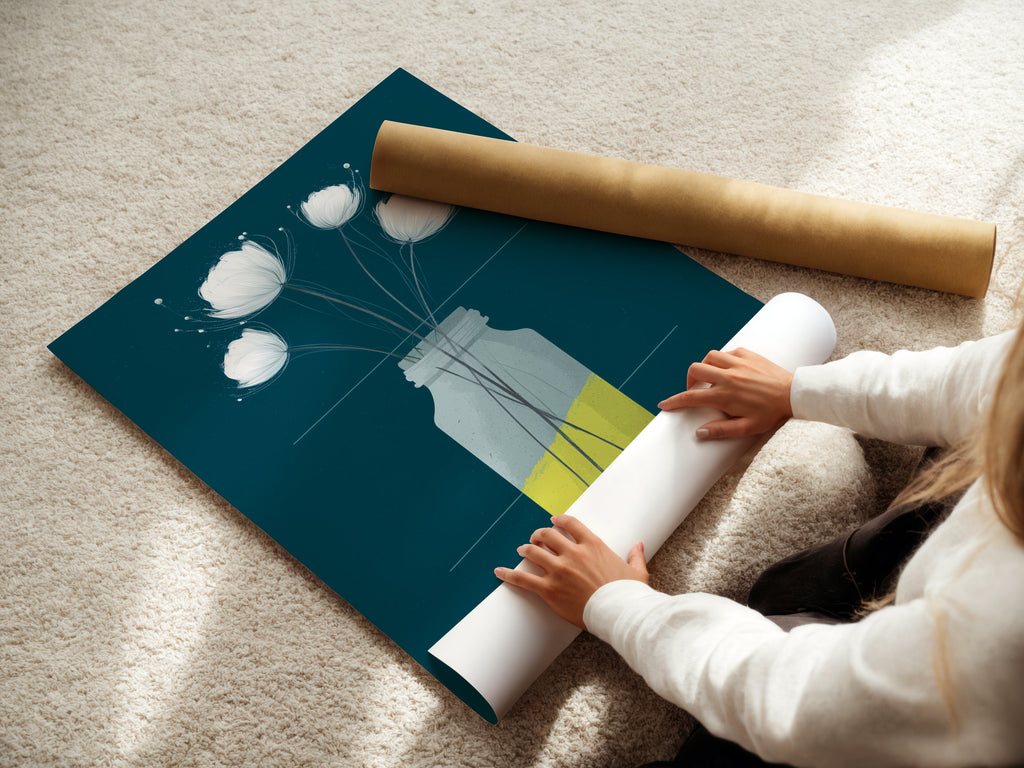 A woman carefully rolls a fine art poster paper. The paper showcases a beautiful floral artwork. Ideal for creating botanical prints or modern art pieces. Perfect for minimalist art and scandi style decor enthusiasts.