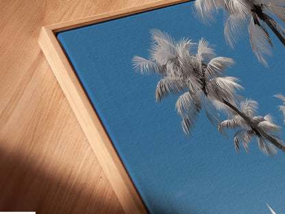 Angled close-up of a canvas print in a floating frame. A stylish way to display tropical beach artwork. Elevate your space with coastal wall art. Palm trees ocean views and summer vibes for your home or office. Discover more framed artwork