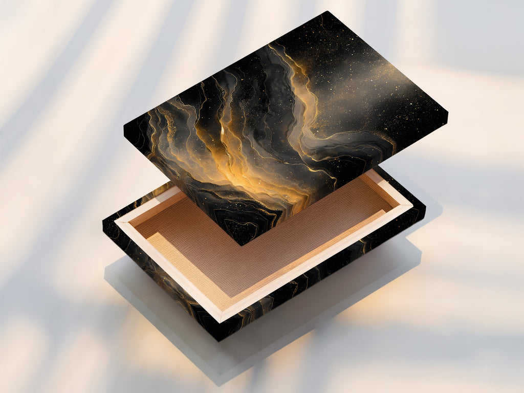 This is a stretched canvas print. The art is an abstract black and gold. The canvas texture enhances the artwork. The stretched canvas is ready to hang. It provides a gallery-worthy presentation. This print will look great in any home. It is a great focal point.