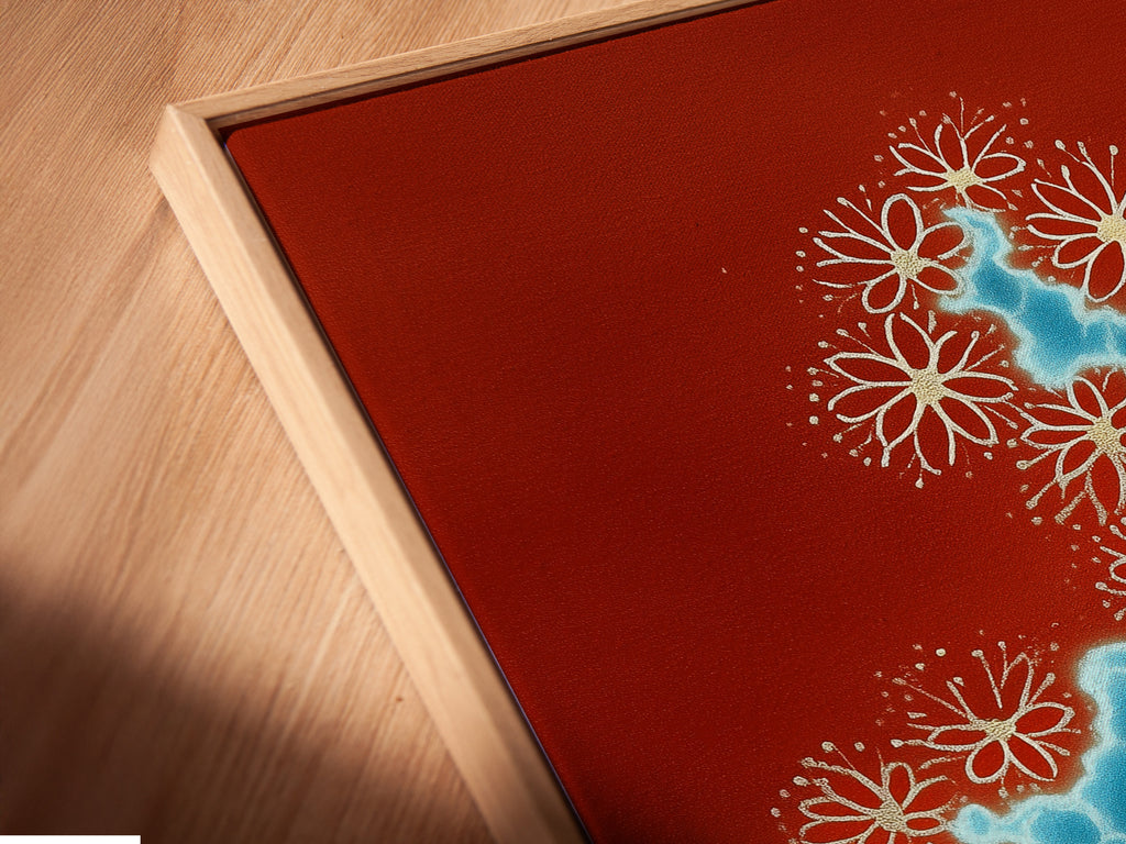 A close-up angled view of a canvas print featuring abstract river art. The artwork is showcased in a floating frame. The terracotta and blue color palette creates a modern botanical art piece. Enhance your space with this unique water flow print.