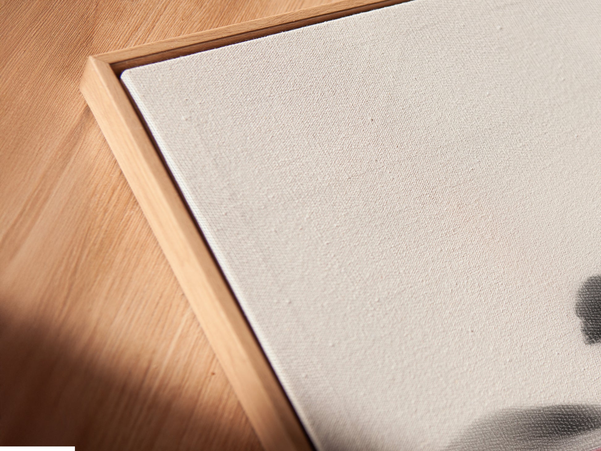 Close-up of the Ink Wash Landscape canvas print in a floating frame. The floating frame gives the artwork a sophisticated look. Minimalist Asian-inspired wall art enhances any interior. This serene zen wall art is perfect for modern spaces. The artwork is great for home staging.