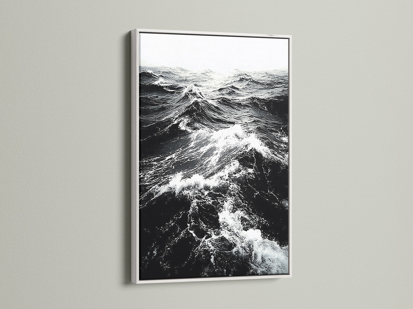A white frame showcases black and white ocean wave artwork. The crisp white frame enhances the sea print. It provides a clean modern look for any room. Shop our coastal wall art collection today.