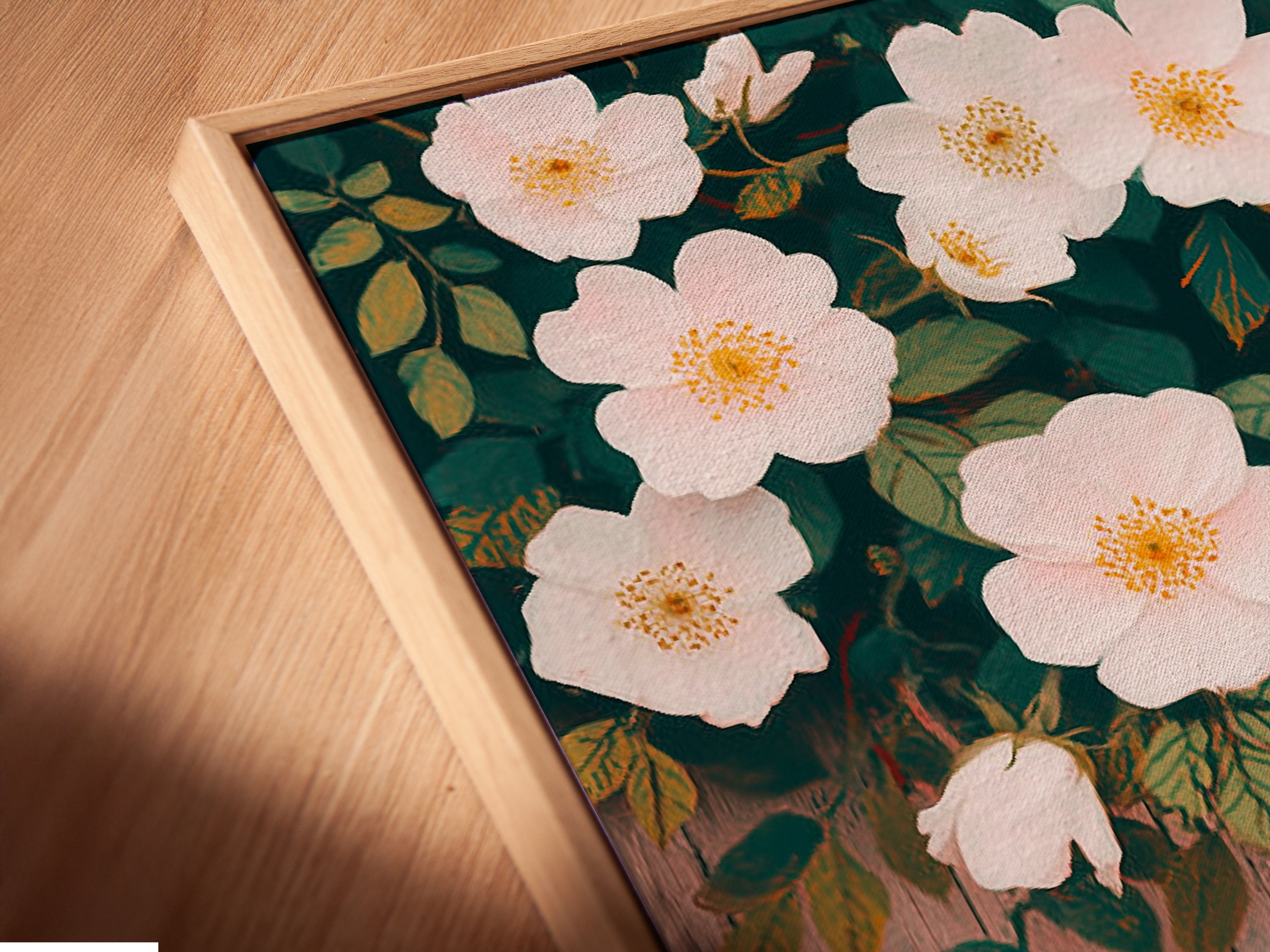 An angled close-up shows a canvas print. The canvas print is set in a floating frame. The artwork features delicate white flowers. The print adds depth and texture to the piece. This flower canvas art is perfect for home decor. Enhance your space with this.