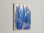 White frame showcasing a desert canvas of blue botanical artwork. Ideal for modern wall art and contemporary wall decor. This cactus art is perfect for eclectic styles. Enhance your living room wall art with this piece.