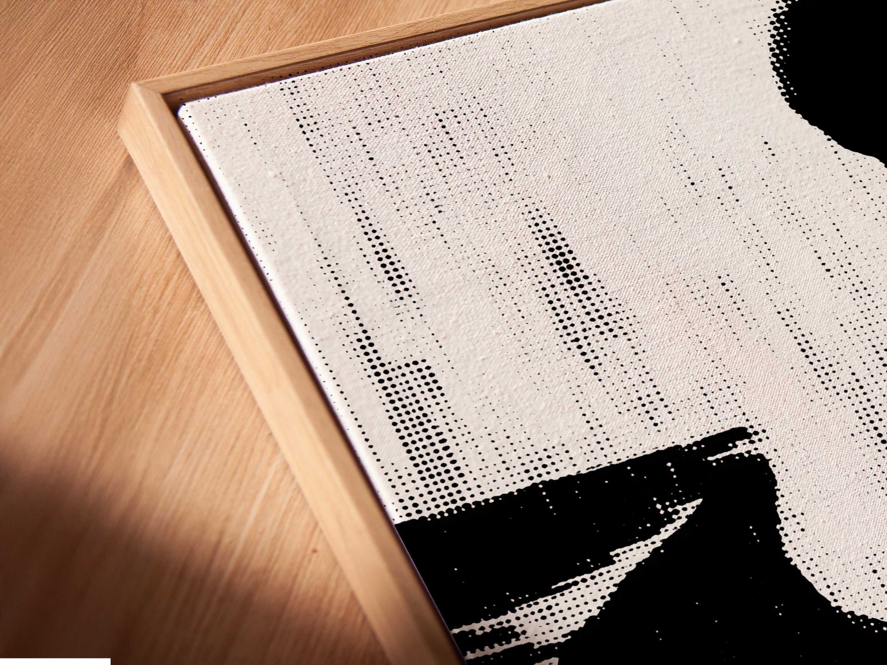 Close up angled view of a canvas print in a floating frame. The musician silhouette art print is a black and white jazz wall art. It provides vintage music art for your home office wall. This is a music lover gift.