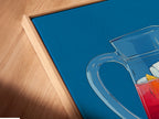 Angled close up of Sangria Pitcher canvas print. It is displayed in a floating frame. The floating frame enhances the artwork's modern feel. This is perfect for kitchen set wall art. It offers a unique display style.