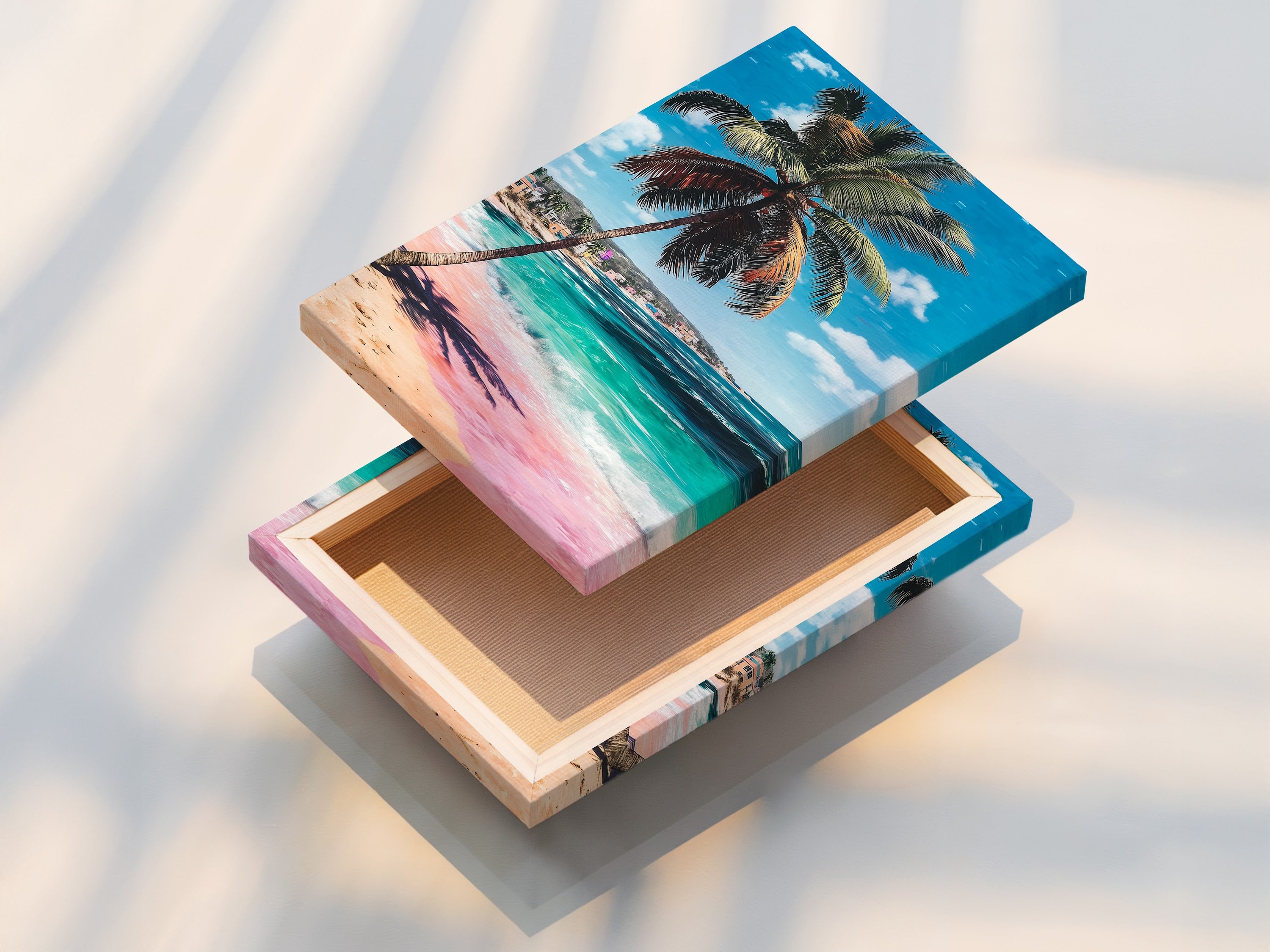 A stretched canvas print of tropical beach artwork. The artwork showcases a palm tree turquoise ocean and pink sand. This beachy wall art is ideal for adding a coastal touch to living rooms or bedrooms.