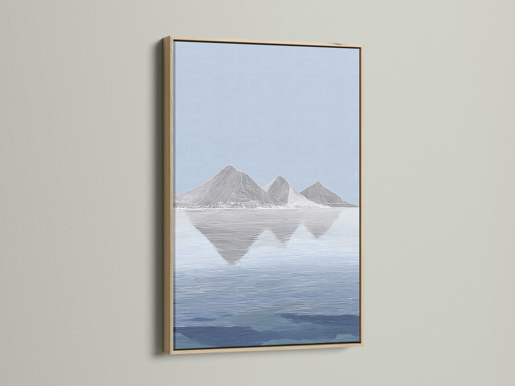 A serene mountain artwork graces a wall in an oak frame. The art captures a tranquil waterscape. The oak frame enhances the artwork's natural beauty. The natural wood frame adds warmth. This piece brings a touch of nature indoors. The frame complements any interior.