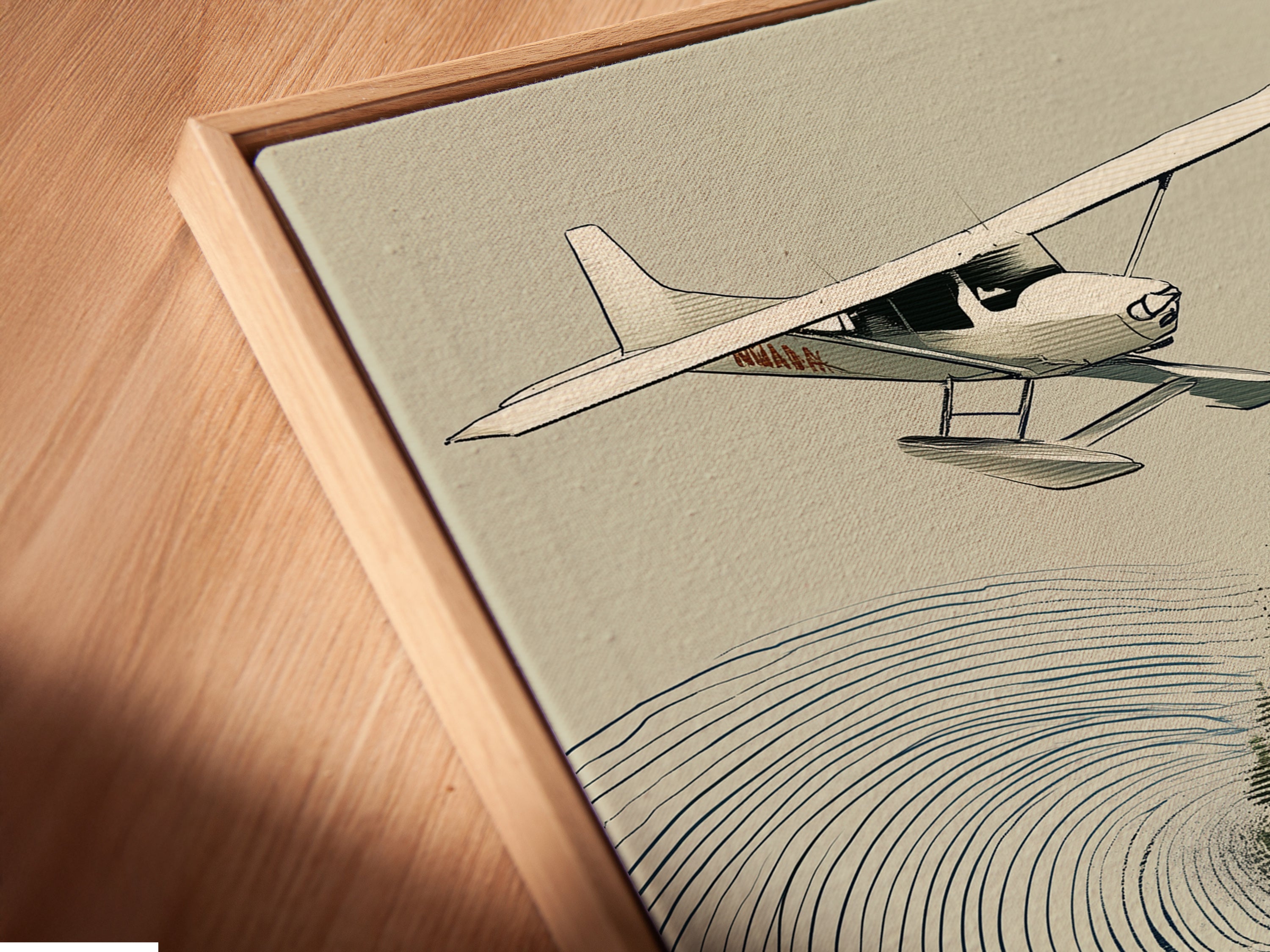 Angled close up of the Seaplane & Salmon canvas print. It is displayed in a floating frame. This vintage-style artwork is perfect for cabin decor. This rustic wall decor enhances any space. The fishing wall art brings nature indoors.