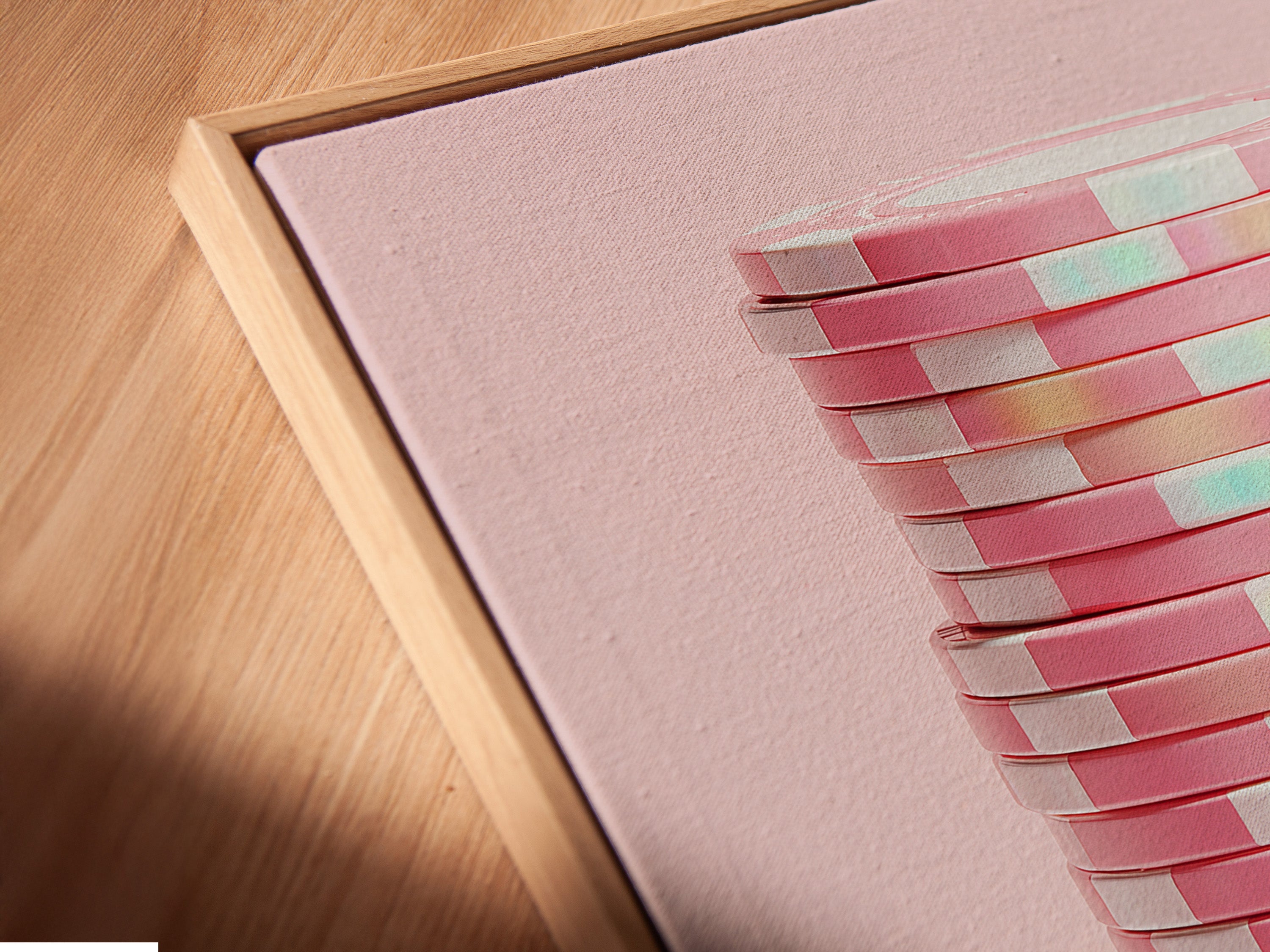Angled close-up of a canvas print in a floating frame. The abstract geometric artwork showcases pink pastel hues. This modern minimalist art is perfect for contemporary spaces. Elevate your office wall decor with this unique piece.