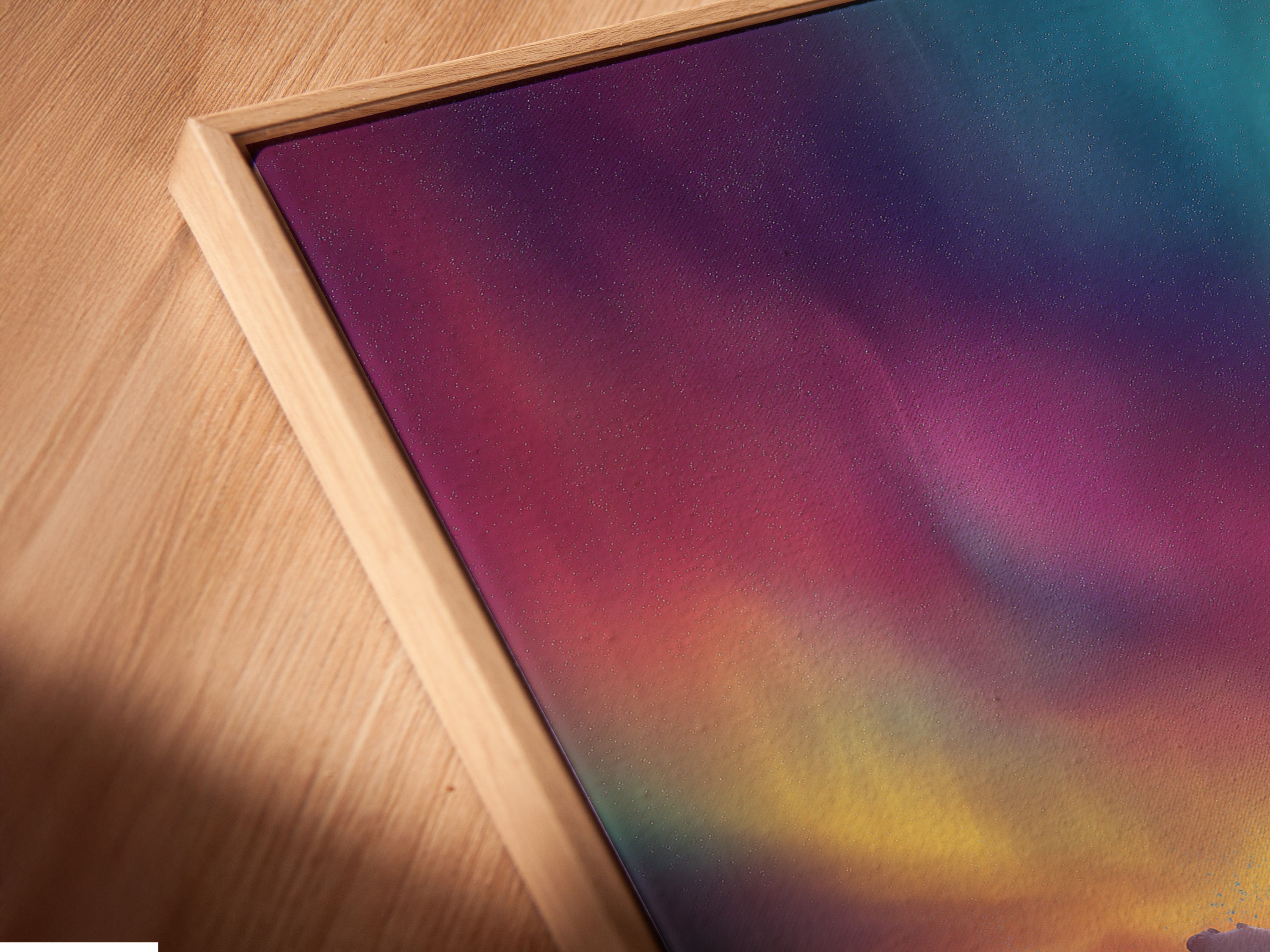 A close-up shot of canvas art in a floating frame. The floating frame gives a modern aesthetic. It enhances the artwork's visual appeal. Perfect for showcasing artwork in a unique way. Elevate your interior with this elegant framing option.