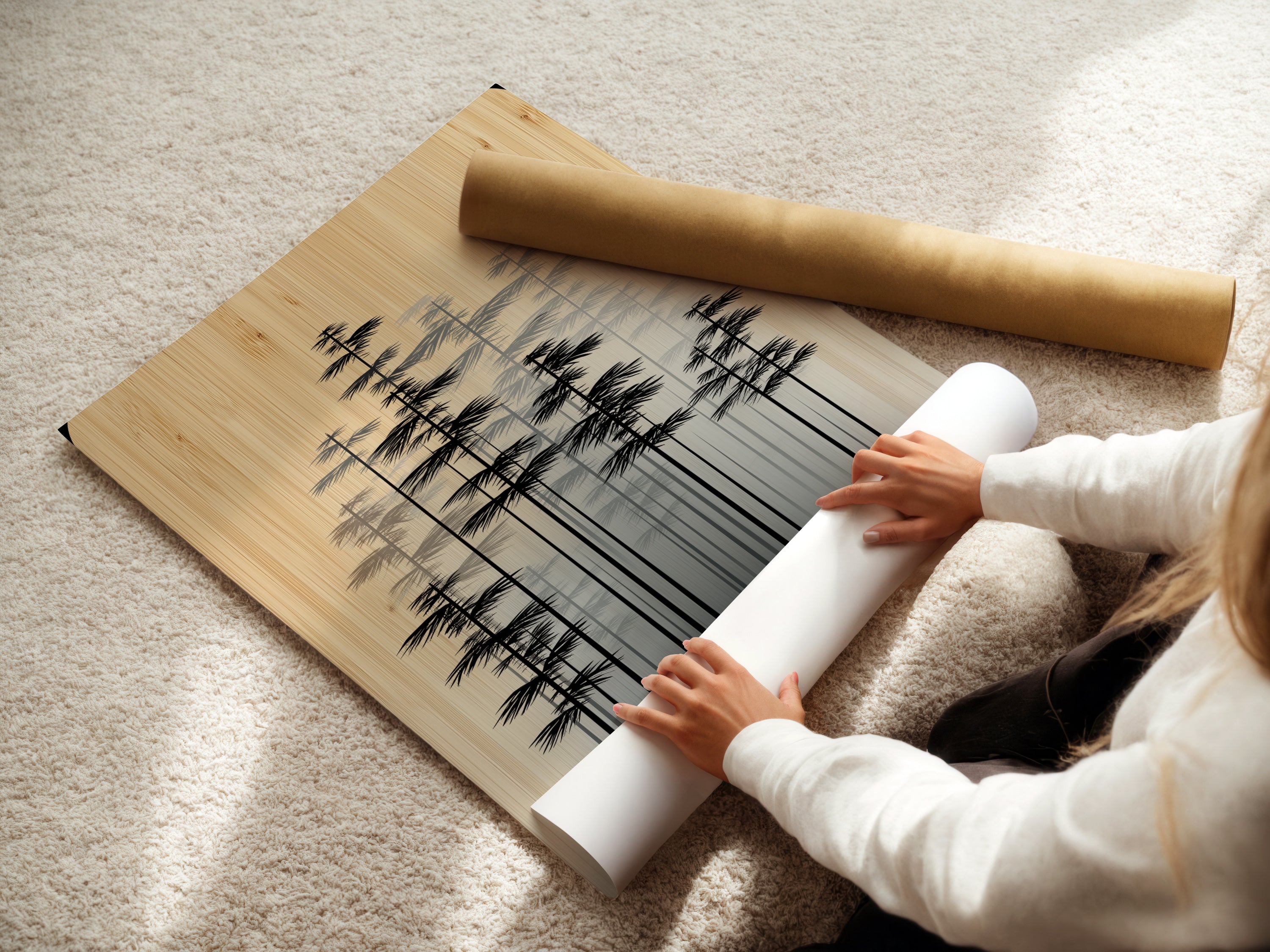 A woman rolling fine art poster paper. She prepares a minimalist forest art print. The Scandinavian wall decor is ready to be framed. This neutral tone canvas is carefully handled. The modern tree artwork is about to be displayed.