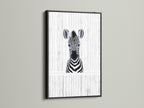 Baby Zebra artwork showcased in a black frame. This modern animal canvas is perfect for a kids room. The black frame enhances the monochrome art. It is ideal for a minimalist nursery or contemporary play area. Zebra wall art perfection.