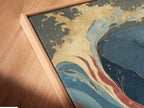 A close-up angled view of the canvas print featuring an elephant in an ocean wave with a floating frame. The blue and gold abstract artwork is a unique piece. It will elevate the style of your living room or bedroom wall decor.