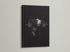 A dog heartbeat artwork is sharply displayed in a black frame. The dark frame provides a bold contrast for the black and white art. This framed print is perfect for a modern veterinary office.