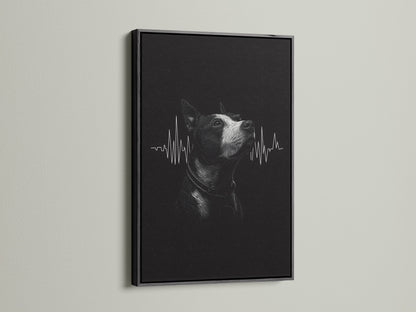 A dog heartbeat artwork is sharply displayed in a black frame. The dark frame provides a bold contrast for the black and white art. This framed print is perfect for a modern veterinary office.