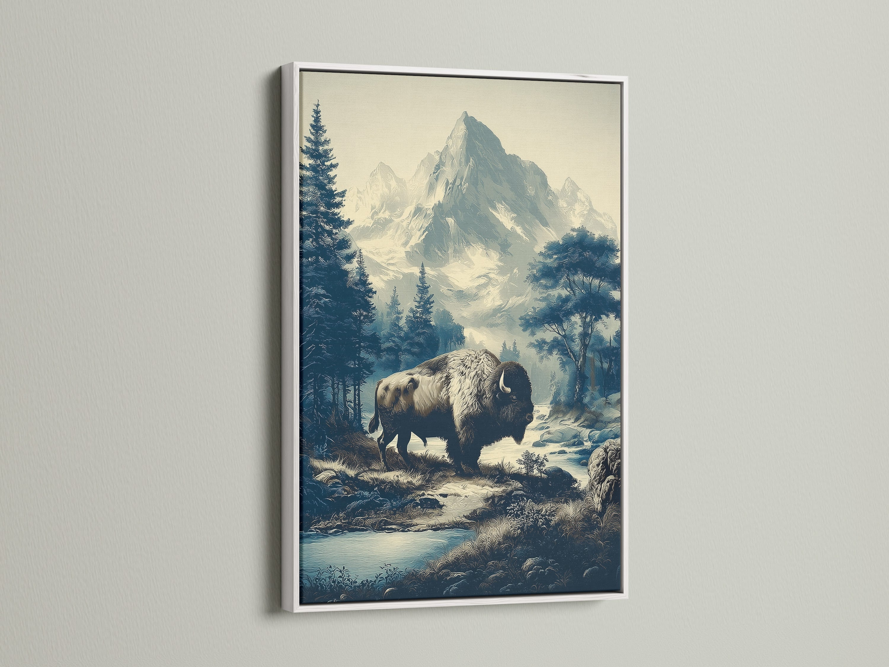 Buffalo Mountain Art with white frame. This wildlife wall decor showcases a mountain landscape. This vintage nature print is perfect for rustic cabin decor. The bison canvas art adds wilderness to your home. The white frame enhances the mountain art print.