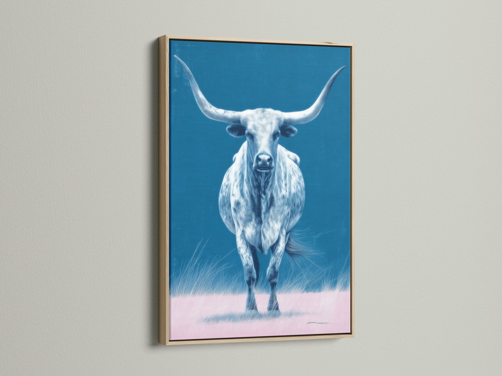 The longhorn bull artwork is showcased in an oak frame. The artwork is a western wall art piece. The blue and pink hues add a modern farmhouse touch. This bull canvas print is perfect for ranch decor.
