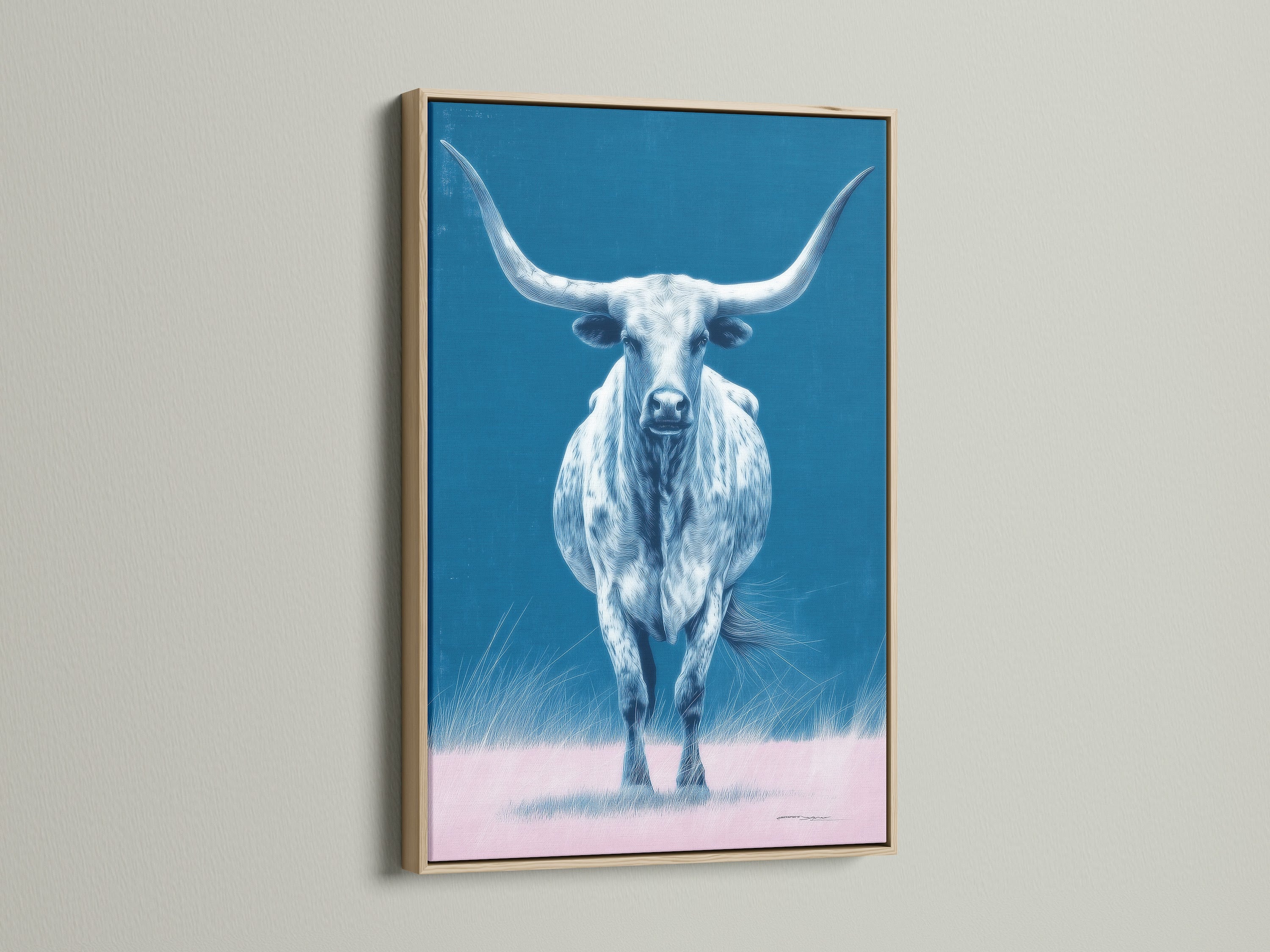 The longhorn bull artwork is showcased in an oak frame. The artwork is a western wall art piece. The blue and pink hues add a modern farmhouse touch. This bull canvas print is perfect for ranch decor.