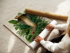 A woman is carefully rolling fine art poster paper. Quality paper ensures a lasting print. Preserve your artwork with professional materials. Discover the best in fine art printing options.
