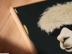 A close-up angled view of a canvas print in a floating frame. The artwork features a cool llama in sunglasses and a suit. The floating frame enhances the modern animal art. It's perfect humorous wall art for any space.