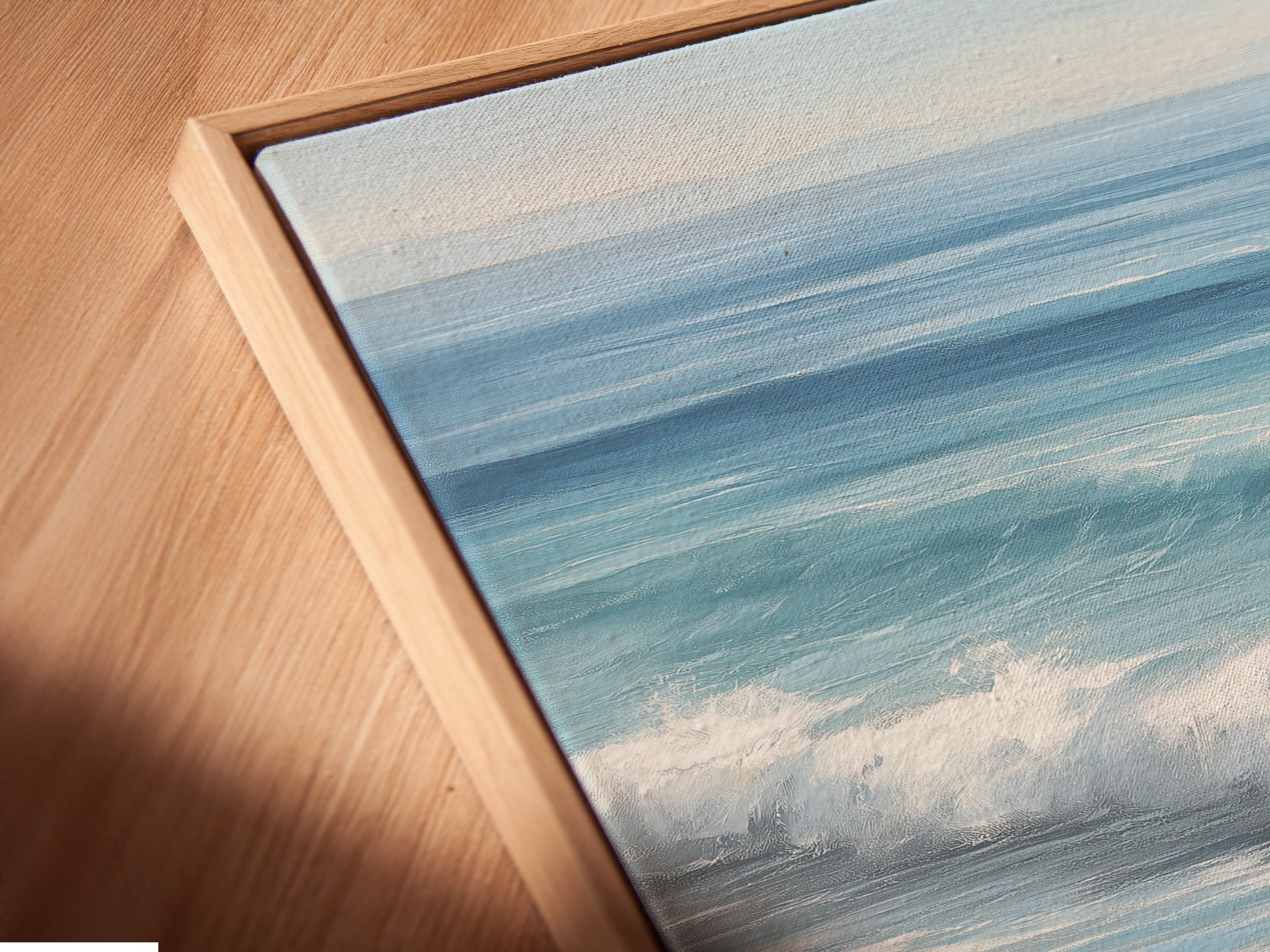 Close-up of a canvas print in a floating frame. This seascape artwork adds depth and dimension to your walls. The beach wall art is perfect for creating a relaxing atmosphere. The coastal print enhances any room.