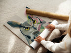 A woman is carefully rolling a fine art poster paper print. The colorful owl artwork is printed on high-quality paper. Perfect for framing or displaying as is. This bird art is a great addition.