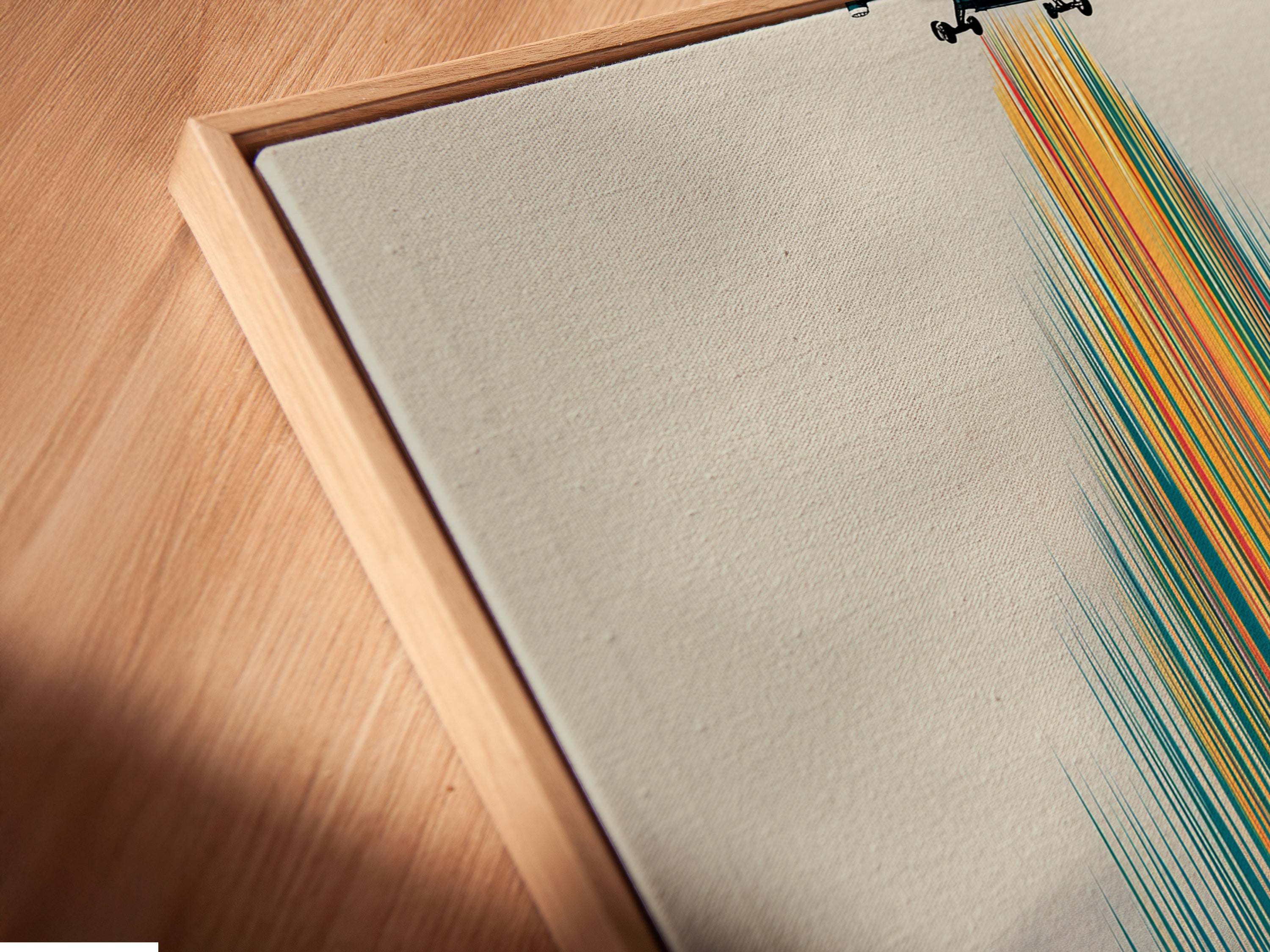 A close-up angled view of the global children canvas artwork in a floating frame. The artwork features a colorful village scene. Children are walking towards the village. The floating frame adds a modern touch. This drone wall art enhances any space.