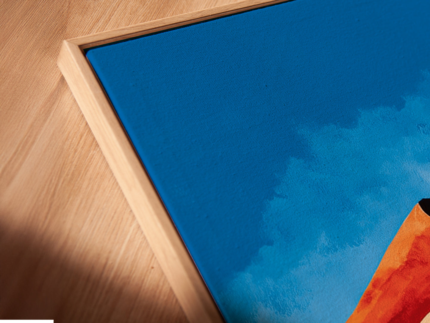 Get a close-up view of our canvas print in a floating frame. The angled shot highlights the depth and texture of the artwork. This Abstract Desert Landscape print enhances any room's ambiance. Its Southwestern decor and modern canvas art make it a standout piece.