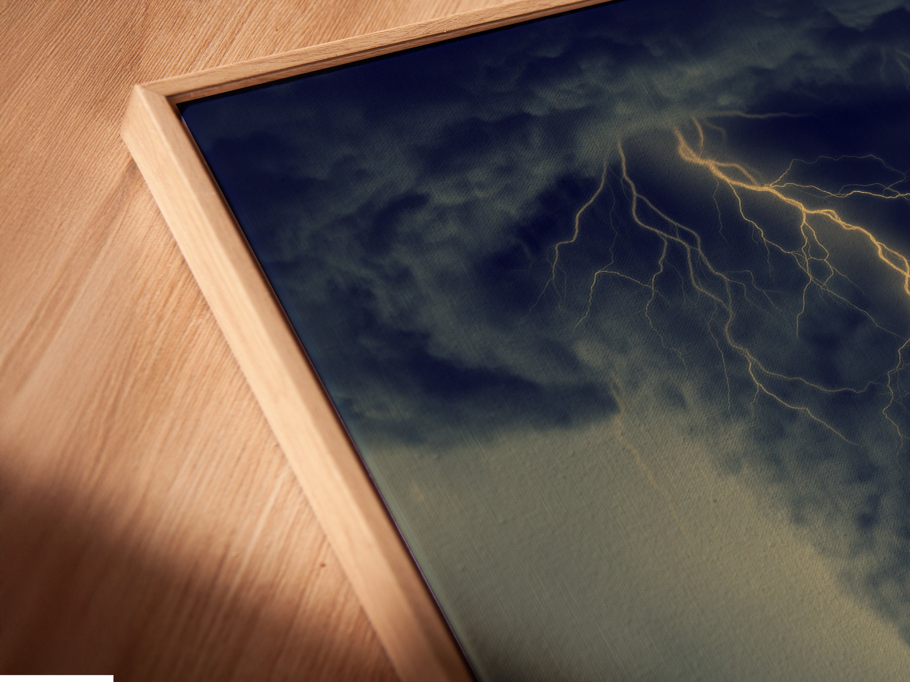 Close up of a canvas print in a floating frame. The dramatic storm artwork is highlighted. This art is perfect for adding a touch of moody decor to any room. The floating frame gives a modern elegant look. This piece is great for minimalist decor