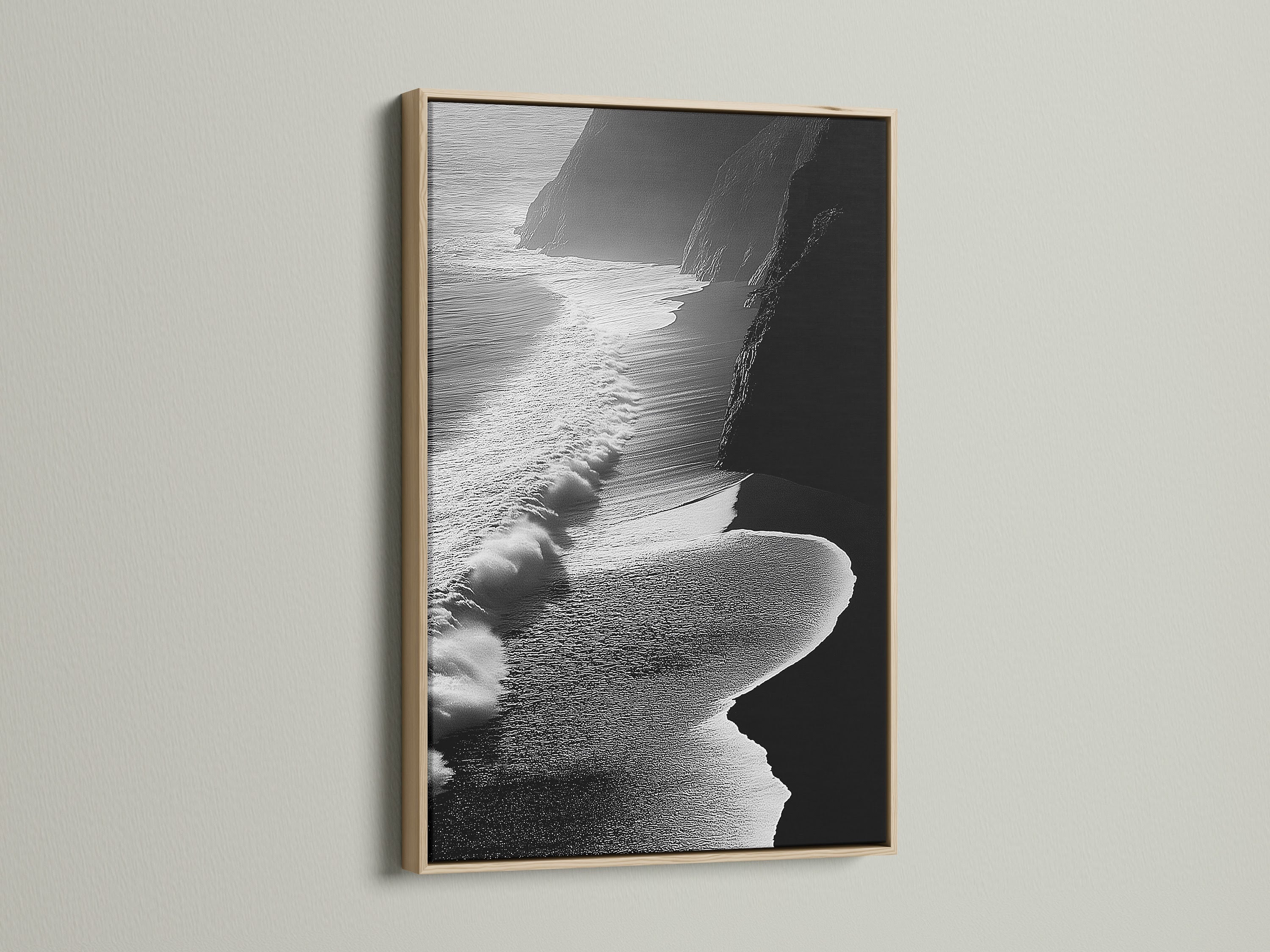 A captivating black and white aerial beach artwork graces the wall. It is framed in a natural oak. The artwork adds an elegant coastal touch to this room. The scene features ocean waves. This artwork is ideal for modern decor. It enhances living rooms and bedrooms. The oak frame complements various interior styles. Discover the beauty of ocean photography today.