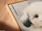 A close-up of a canvas print in a floating frame. This adorable puppy art enhances any space with its Japanese art style. Perfect for modern wall art for nurseries or kids' rooms. This cute puppy artwork is ideal for pet clinics and boutiques. Add this pet portrait print to your home today