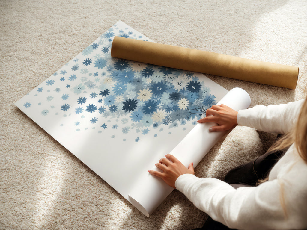 A woman is carefully rolling a fine art poster paper featuring a blue floral artwork. The pastel botanical art is ready for framing or display. This whimsical flower tree art print is perfect for adding a touch of nature to any space. Ideal for nursery decor.