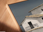 Close-up of a canvas print in a floating frame showcasing Mediterranean house artwork. The minimalist white building art enhances any space. Perfect for coastal wall art enthusiasts. Discover the beauty of our architecture print. Shop now for unique art.