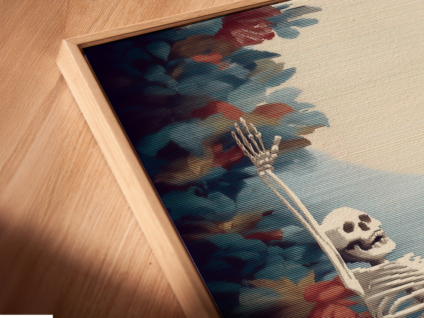 A close-up angled view of a canvas print in a floating frame. The artwork features a skeleton among autumn leaves. This piece is ideal for adding a gothic touch to your home decor.